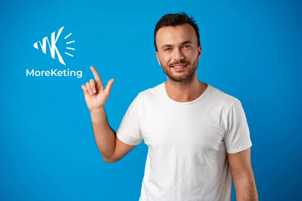 Male customer presenting MoreKeting brand and logo, pointing finger at copy space